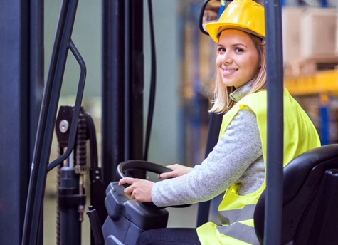 A girl operating a forklift